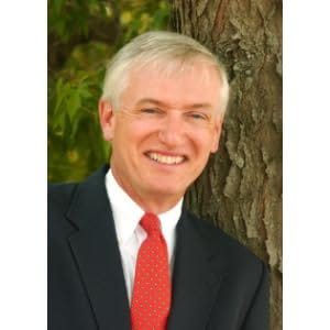 Covers of Robert Thacker books about Alice Munro. See links in text. Photo of Robert Thacker smiling beside a tree wearing a dark jacket, white shirt, and red tie.
