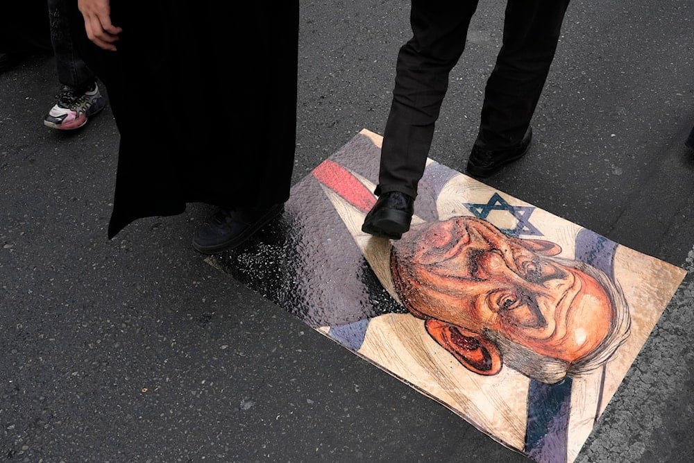 Iranian demonstrators walk on a caricature of the Israeli Prime Minister Benjamin Netanyahu during the annual Quds Day rally in support of Palestinians, in Tehran, Iran, Friday, March 28, 2025 (AP) Iranian demonstrators walk on a caricature of the Israeli Prime Minister Benjamin Netanyahu during the annual Quds Day rally in support of Palestinians, in Tehran, Iran, Friday, March 28, 2025 (AP)