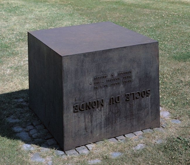 A plinth installed upside down in the grounds of the Herning Museum of Contemporary Art in Denmark. It reads SOCLE DU MONDE (the base of the Earth), and was created in 1961 – a date which reads the same way upside down
