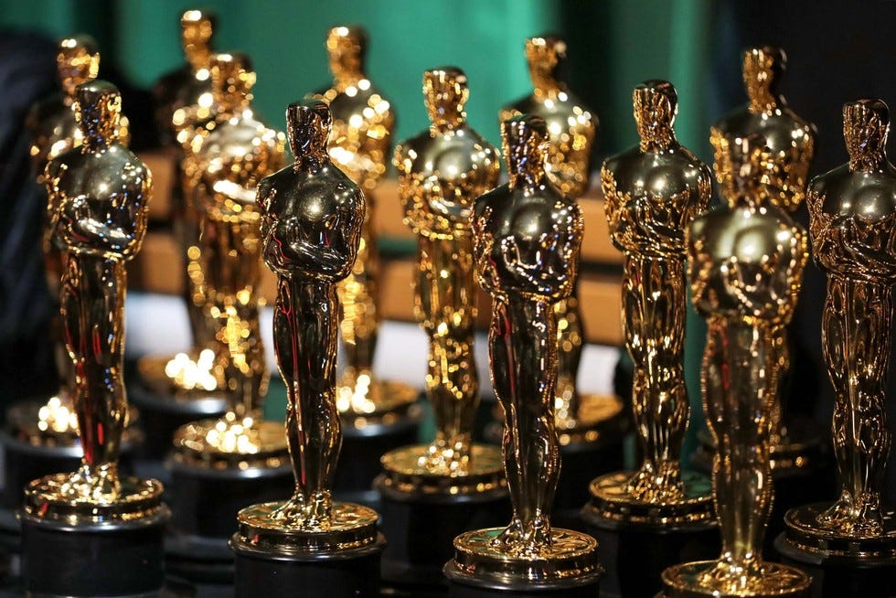 Multiple Oscar awards on display.