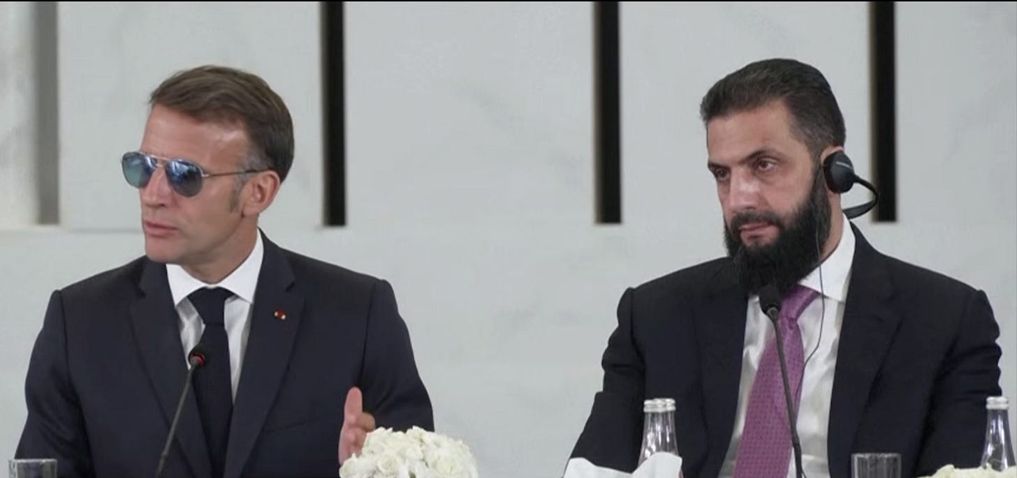 Emmanuel Macron and Ahmed al-Sharaa sitting side-by-side Emmanuel Macron and Ahmed al-Sharaa sitting side-by-side