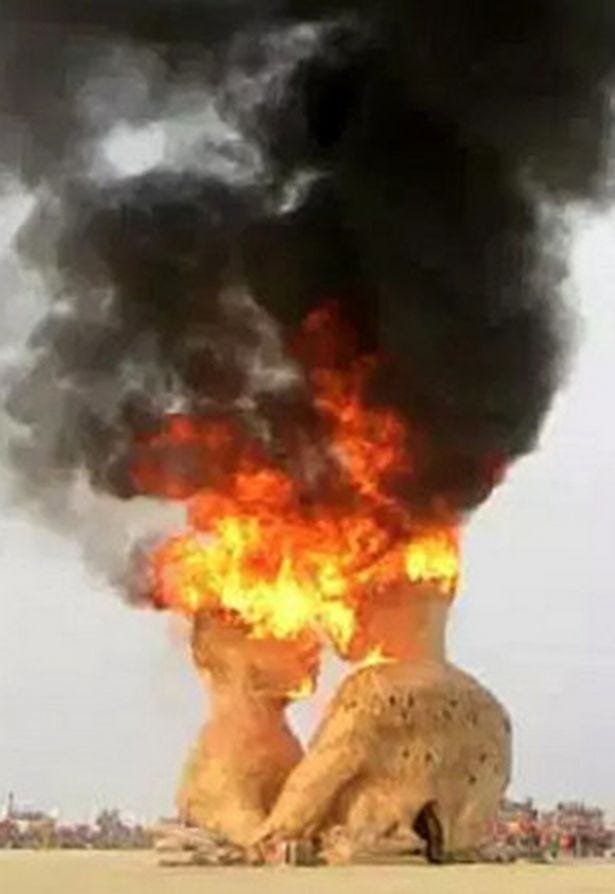 The ritualistic burning of a giant human-shaped effigy send smoke billowing The ritualistic burning of a giant human-shaped effigy send smoke billowing
