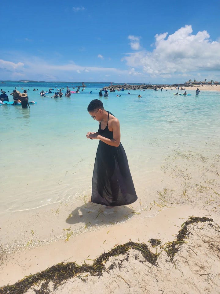 Photos of the Caribbean ocean, the sandy beaches, and water and sky! And a black chick taking pictures of everything and sitting drinking a pineapple drink.