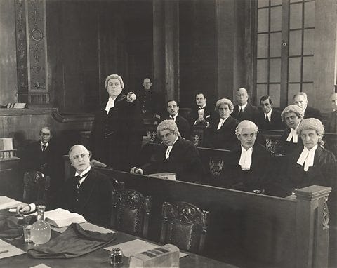 Photo of old courtroom with barristers wearing wigs, a tradition dating back to the reign of Charles II