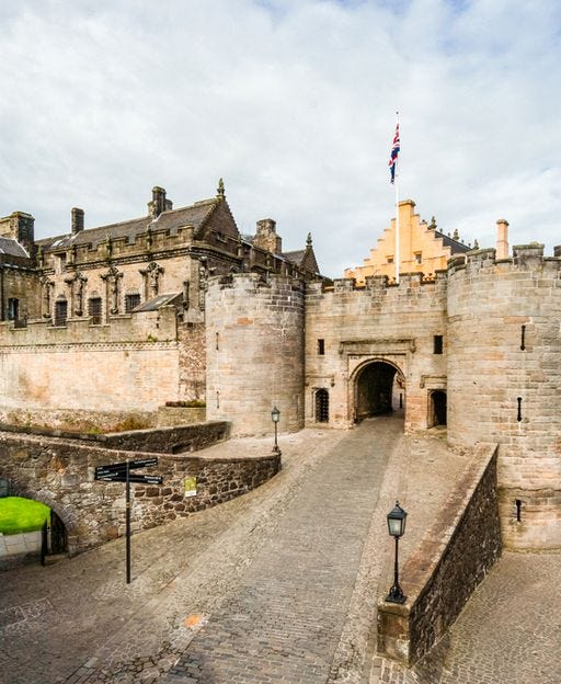 Stirling Castle courtyard with historic stone walls and towers against a cloudy sky, Stirling, Scotland