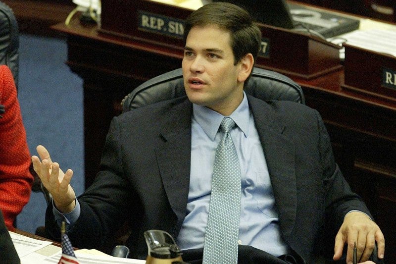 Then-Representative Marco Rubio (aged 32) converses with a colleague during a House session in Tallahassee, Florida, on April 1, 2004. Then-Representative Marco Rubio (aged 32) converses with a colleague during a House session in Tallahassee, Florida, on April 1, 2004.