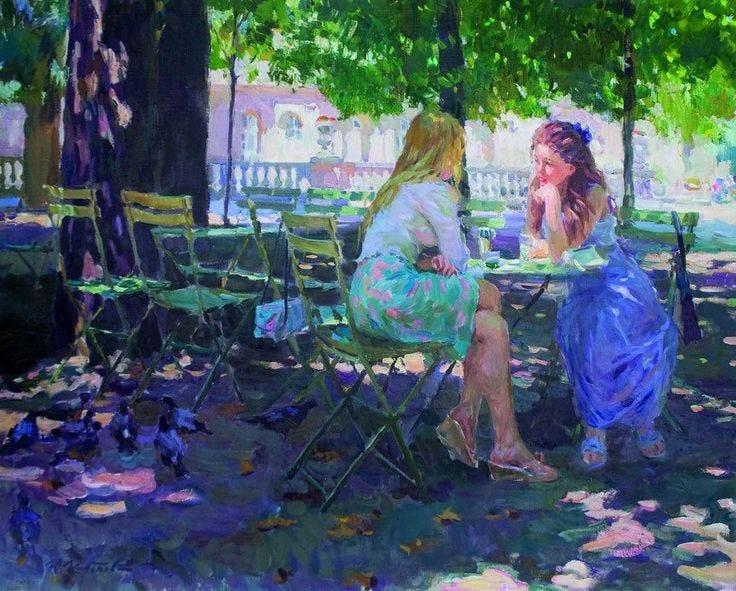This may contain: two women sitting at a table in the park This may contain: two women sitting at a table in the park