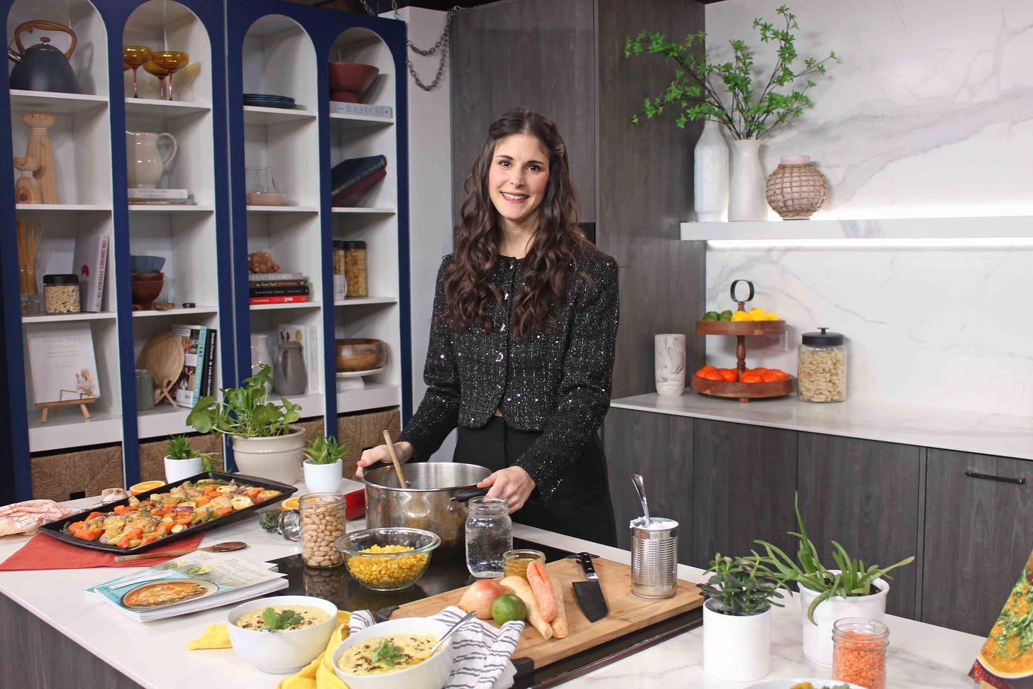 Jesse Lane Lee in a large kitchen in front of prepared foods Jesse Lane Lee in a large kitchen in front of prepared foods