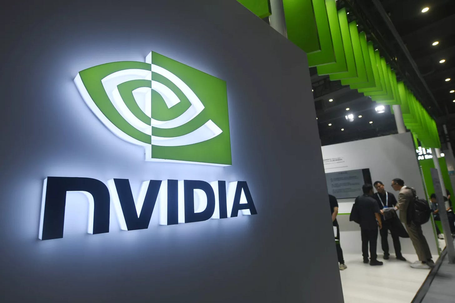 People visit Nvidia booth during an industry conference.