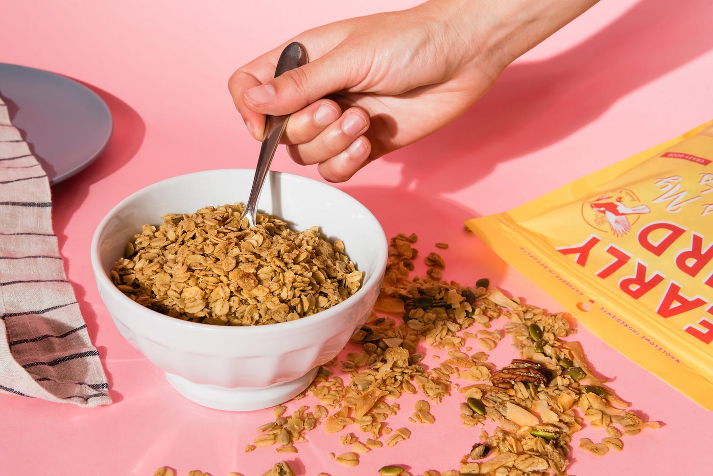 Early Bird Granola in a bowl with pink background.