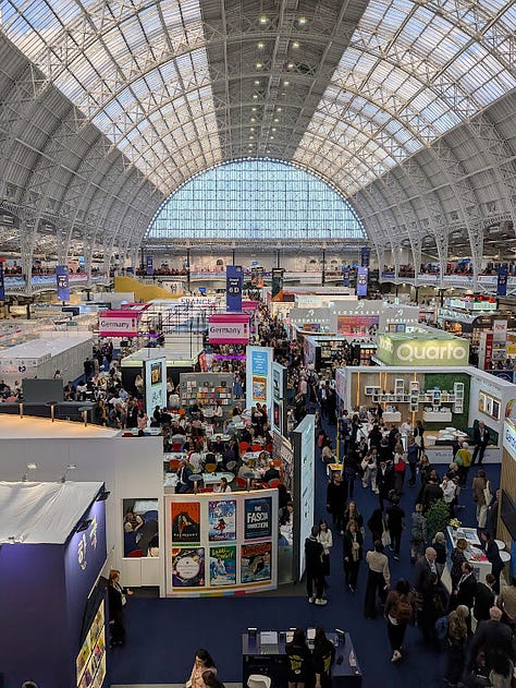 3 photos: A wide shot of the exhibition, picture of Adukeh, a picture of a book stand at the fair.