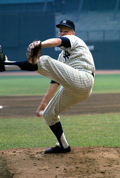 Pitcher Jim Bouton of the New York Yankees simulates his pitching...