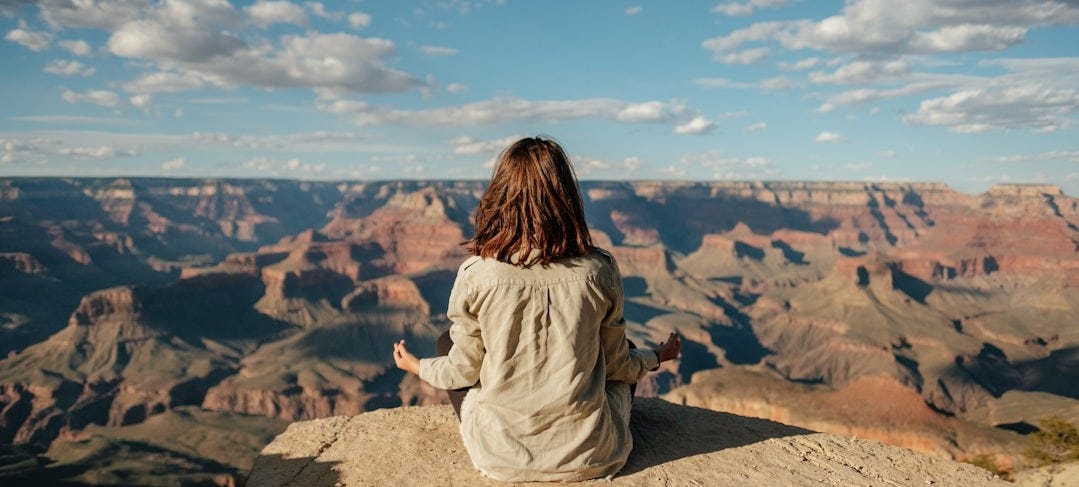 woman sitting on hill woman sitting on hill