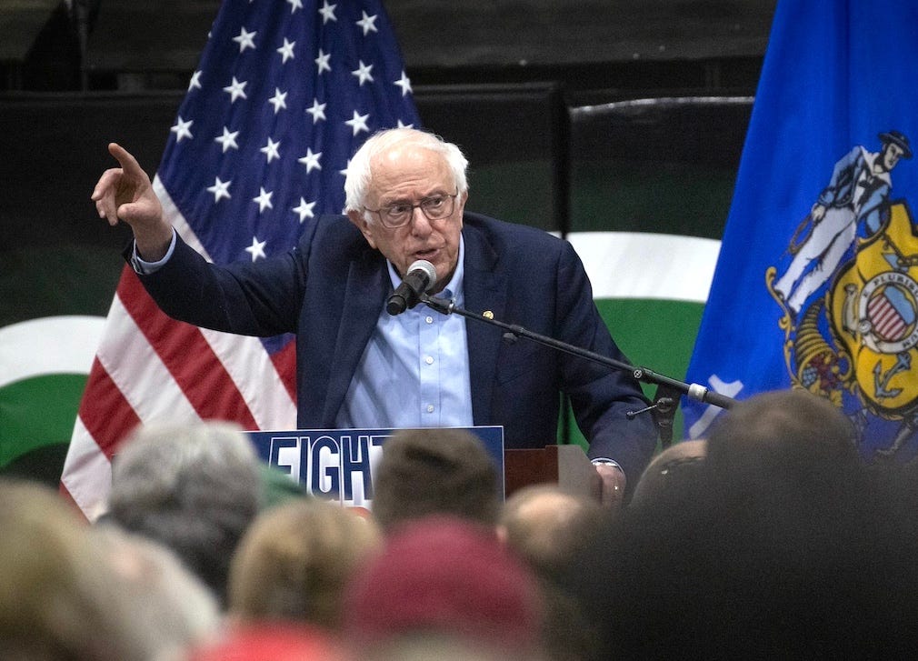 A person standing at a podium with a microphone and a flag behind him

AI-generated content may be incorrect.