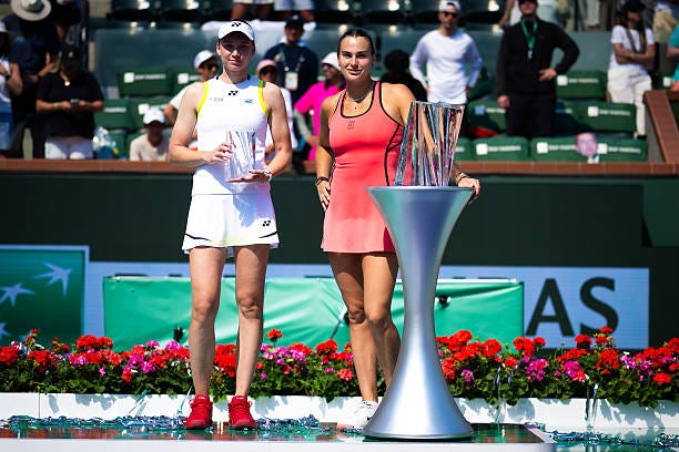 Runner-up Elena Rybakina of Kazakhstan and champion Aryna Sabalenka pose with their trophies after the womens singles final on Day 12 of the BNP... Runner-up Elena Rybakina of Kazakhstan and champion Aryna Sabalenka pose with their trophies after the womens singles final on Day 12 of the BNP...