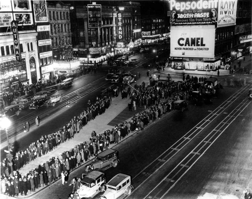 A black and white image of a long line of people in New York's Times Square in the 1930s A black and white image of a long line of people in New York's Times Square in the 1930s