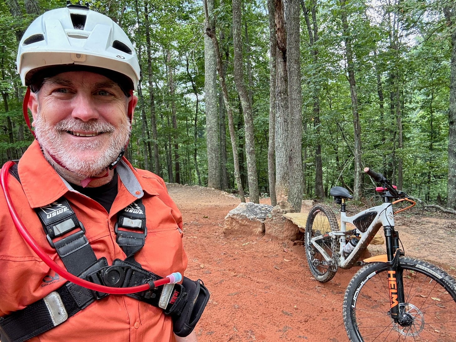 Mountain biker smiling during a rest stop on a forest trail in Roanoke, Virginia.