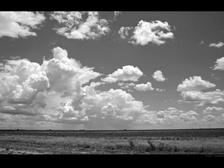 Puffy cloud sky over field