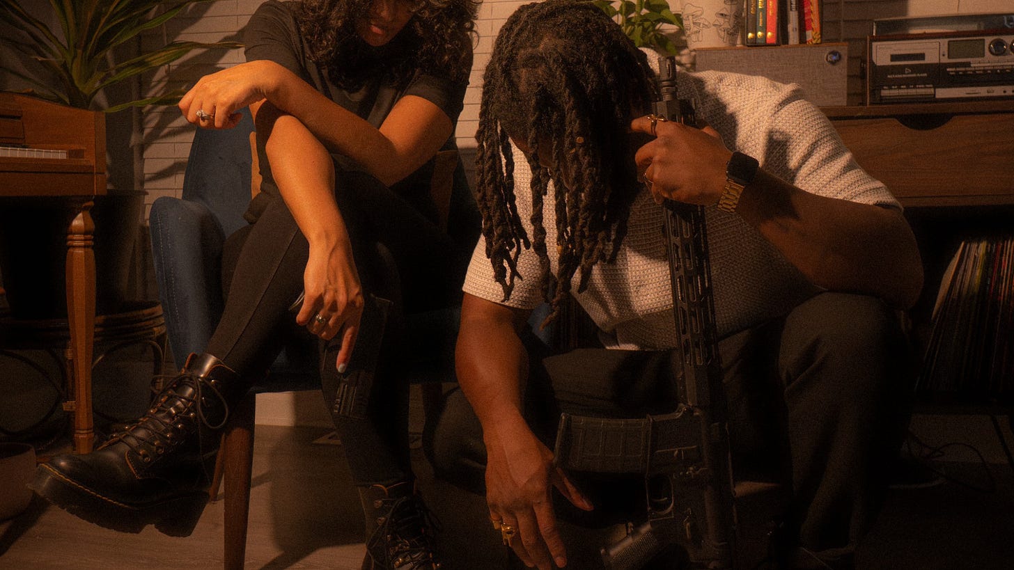 Pictured: Zeeky El and wife, showing their support for the 2nd Amendment in a militant and mysterious pose. Pictured: Zeeky El and wife, showing their support for the 2nd Amendment in a militant and mysterious pose.