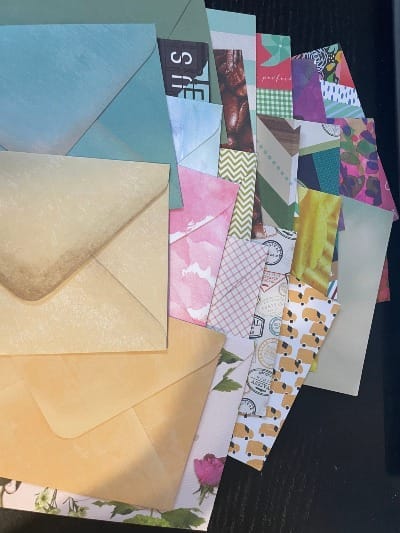 Messy stack of envelopes in various patterns and colors