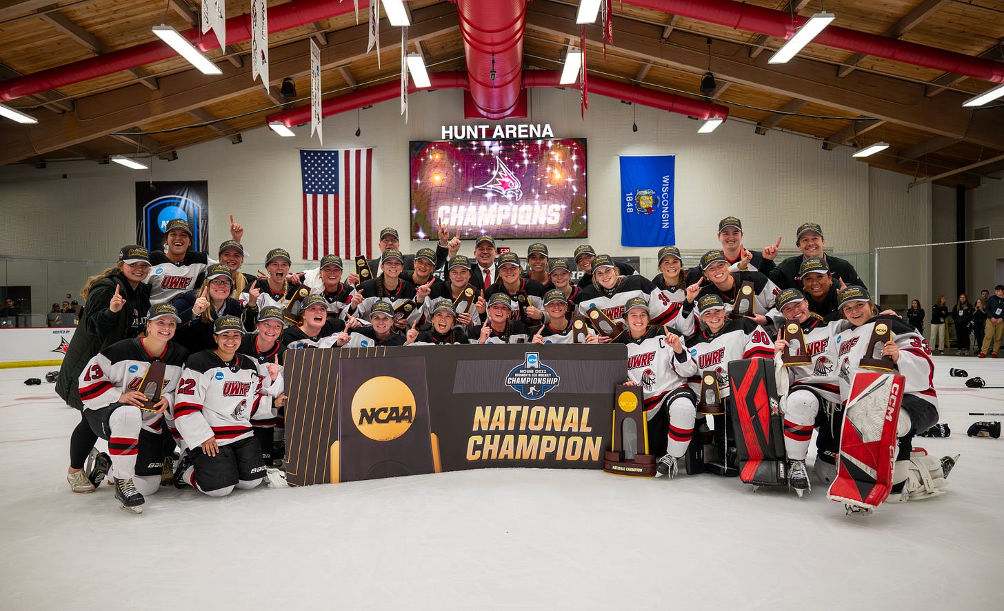 Women's college hockey players pose with a trophy after winning a national championship Women's college hockey players pose with a trophy after winning a national championship