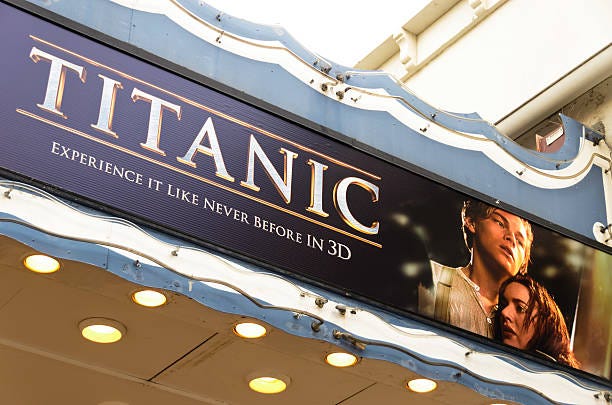 Theater Marquee with Titanic 3D Movie Poster "Los Angeles, California, USA - April 14, 2012: Poster of the movie Titanic 3D on the marquee of the Fox Village Theatre in the Westwood Village district. The film is the 3D version of the historical drama originally released in 1997, starring Leonardo DiCaprio and Kate Winslet." titantic stock pictures, royalty-free photos & images