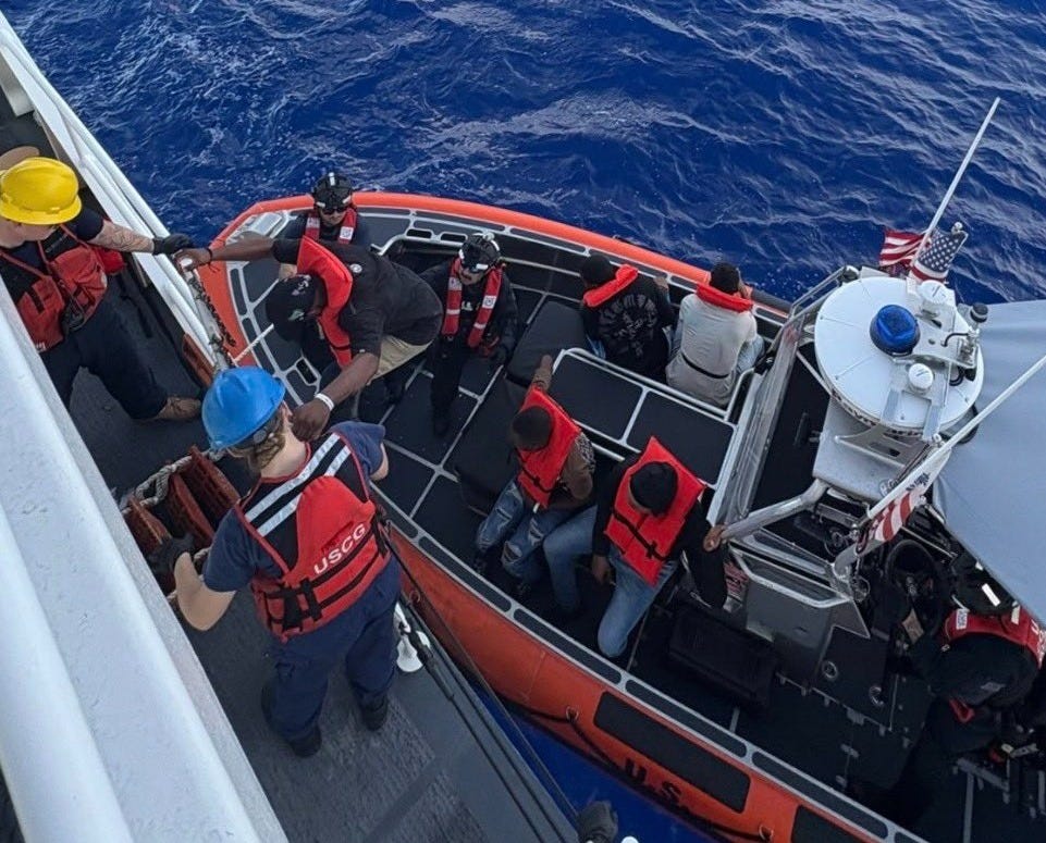 Migrants rescued from an overloaded human smuggling vessel are transferred by a small boat crew from the Winslow Griesser to the safety of the cutter in the Mona Passage. (US Coast Guard photo)