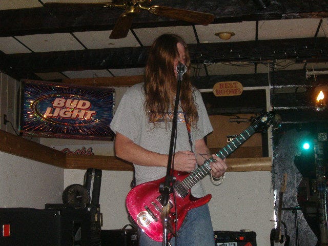 Jim singing and playing his guitar. Jim singing and playing his guitar.