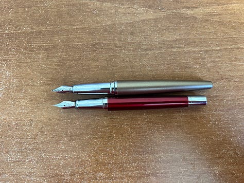 Two fountain pens laid out to compare the size of the Ellington Classic fountain pen with an older Cross Fountain pen