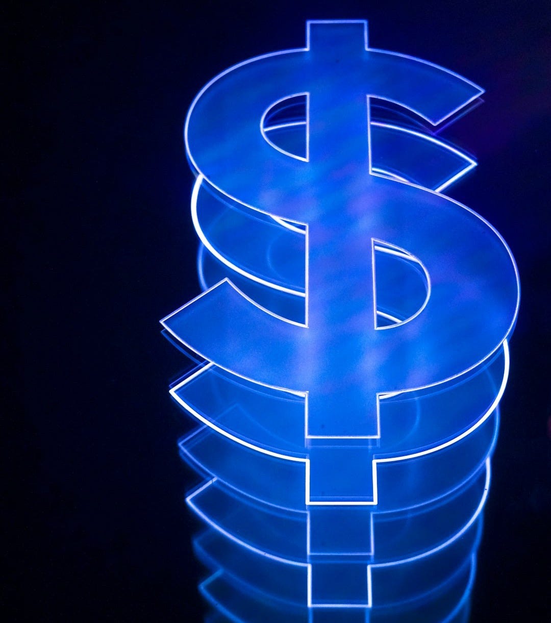 a lit up dollar sign sitting on top of a table