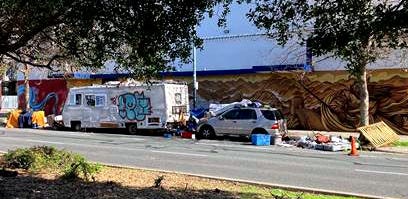 One of dozens of RVs on Mandela Parkway — this one on Mandela Pkwy and 28th St. This RV encampment has been parked at this location for two years — obscuring a stop sign; spilling onto the street and sidewalk; often blocking the sidewalk entirely. This RV is around 60 yards from a daycare center. (Image source: Sanford Forte) One of dozens of RVs on Mandela Parkway — this one on Mandela Pkwy and 28th St. This RV encampment has been parked at this location for two years — obscuring a stop sign; spilling onto the street and sidewalk; often blocking the sidewalk entirely. This RV is around 60 yards from a daycare center. (Image source: Sanford Forte)