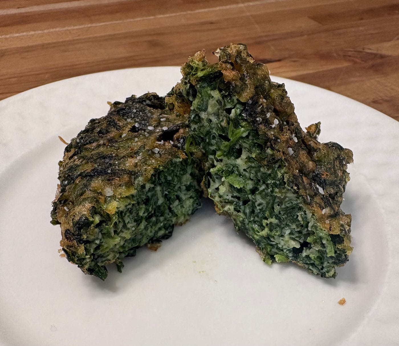 The finished croquette, presented cut in half, on a white plate