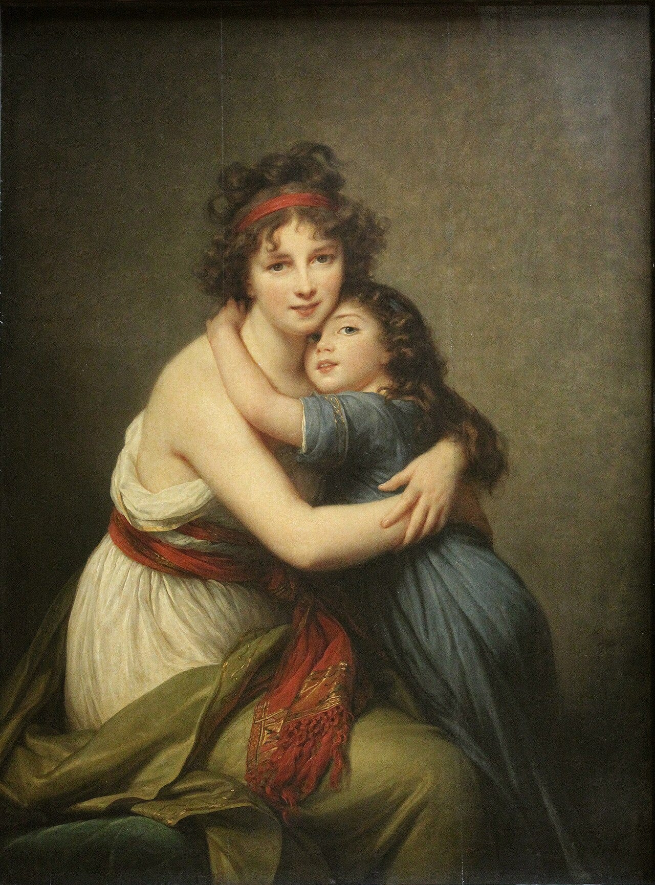 A mother embracing her young daughter cheek to cheek A mother embracing her young daughter cheek to cheek
