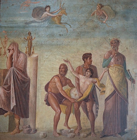 photograph of a wall painting showing the sacrifice of ipihgenia including a nube girl in the arms of three male figures, a woman with her head covered, and a partial image of Artemis with a deer in the sky