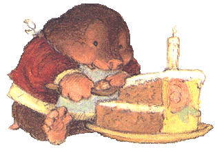 This may contain: a brown teddy bear sitting in front of a cake with a lit candle on it