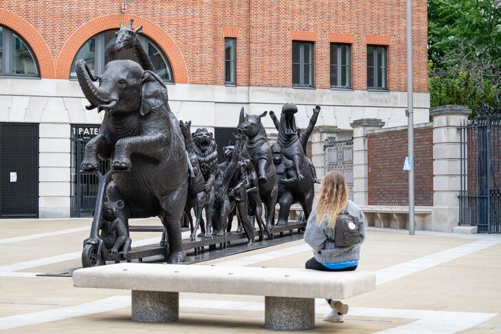 A person sitting and admiring the sculpture