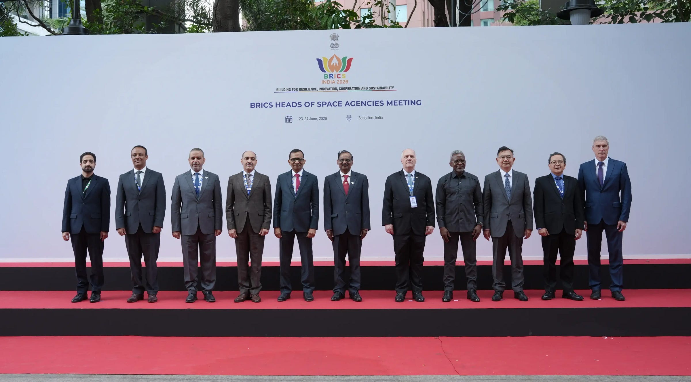 Space agency heads and senior officials posing for an official photo during the June 2026 meetings, China National Space Administration’s Li Guoping is third in from the right.