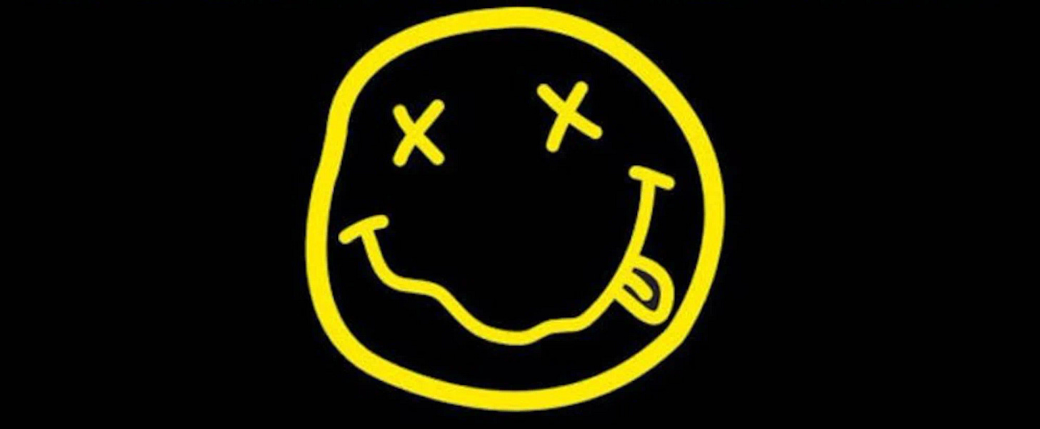 The Story and Meaning Behind Nirvana's Infamous Smiley Face ...