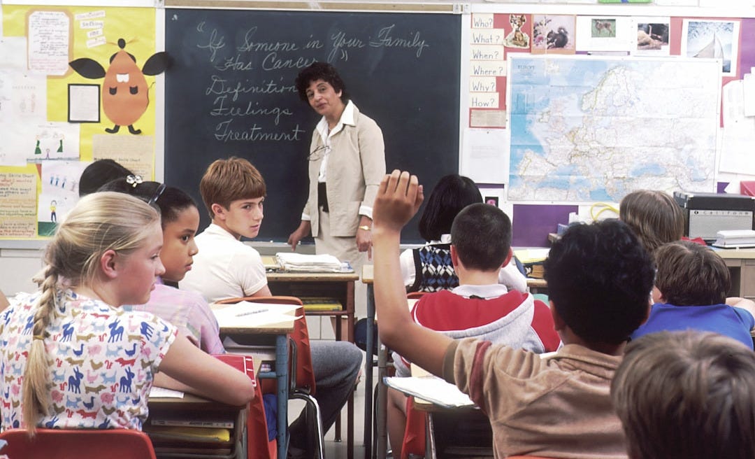 woman standing in front of children woman standing in front of children