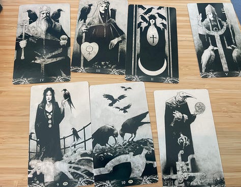 Images of New Orleans' French Quarter + swamp, including iconic balconies dripping in ferns, a swamp gator near Slidell, Jordan in front of blue doors, a cemetary and two tarot card spreads.