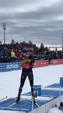 a person on skis in front of a decathlon banner