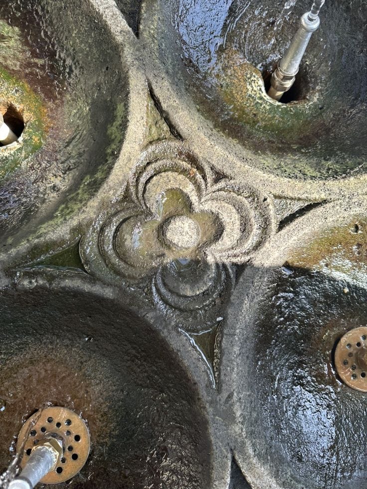 This may contain: several pots and pans sitting on top of each other with water running down them