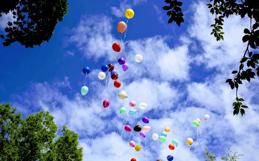 assorted-color balloons flying on the sky assorted-color balloons flying on the sky
