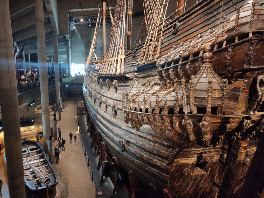 A long view of the Vasa from behind; the back of the ship is particularly ornately decorated