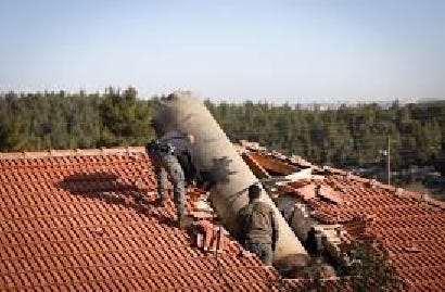 Huge piece of Iranian missile in roof of Israeli house, with 3 soldiers near it