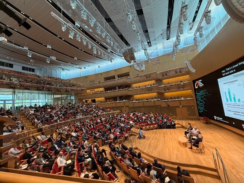 A group of people in a auditorium

AI-generated content may be incorrect.
