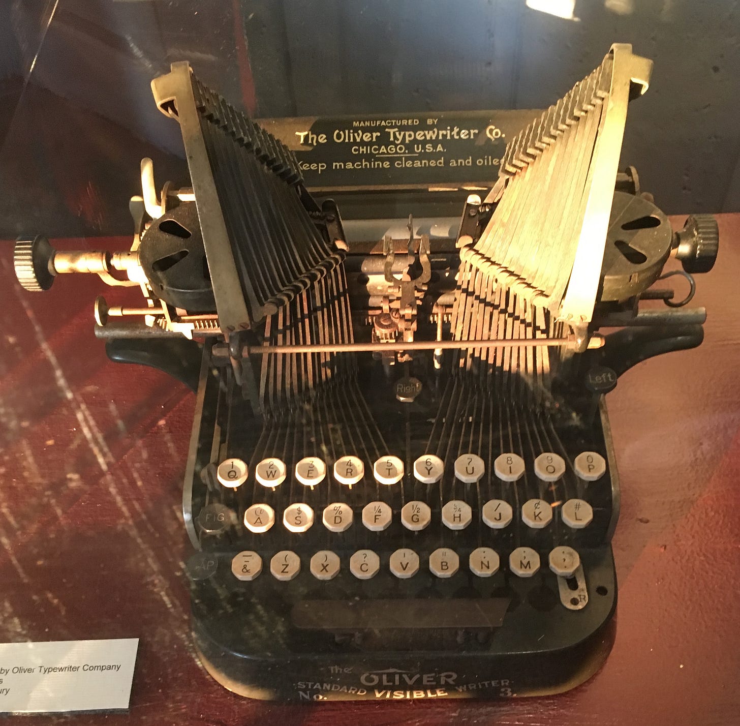 Photo of an antique typewriter that is part of a museum display.