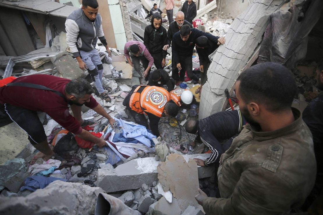 DEIR AL-BALAH, GAZA - DECEMBER 01: Palestinian search and rescue team and civilians gather to conduct search and rescue operation among rubble of buildings following the end of the week-long 'humanitarian pause' after Israeli attacks on Al-Maghazi refugee camp in Deir Al Balah, Gaza on December 01, 2023. (Photo by Ashraf Amra/Anadolu via Getty Images) DEIR AL-BALAH, GAZA - DECEMBER 01: Palestinian search and rescue team and civilians gather to conduct search and rescue operation among rubble of buildings following the end of the week-long 'humanitarian pause' after Israeli attacks on Al-Maghazi refugee camp in Deir Al Balah, Gaza on December 01, 2023. (Photo by Ashraf Amra/Anadolu via Getty Images)