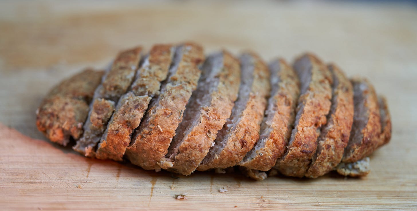 Unadorned meatloaf.Basically sliced brown meat
