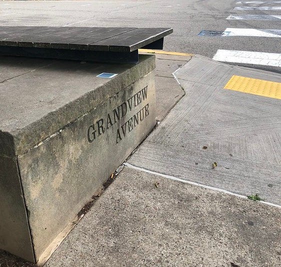 Grandview Ave sign etched into a concrete seating block.